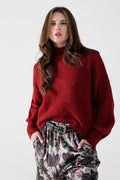 Fluffy red sweater with high neck and balloon sleeves