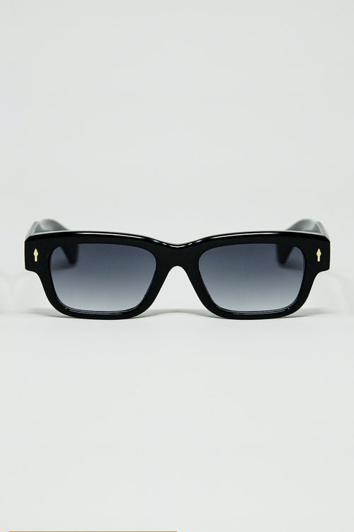 Black sunglasses with oval frame with gold detail — view 1 of 3