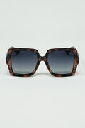 Sunglasses with a brown print frame and black temples