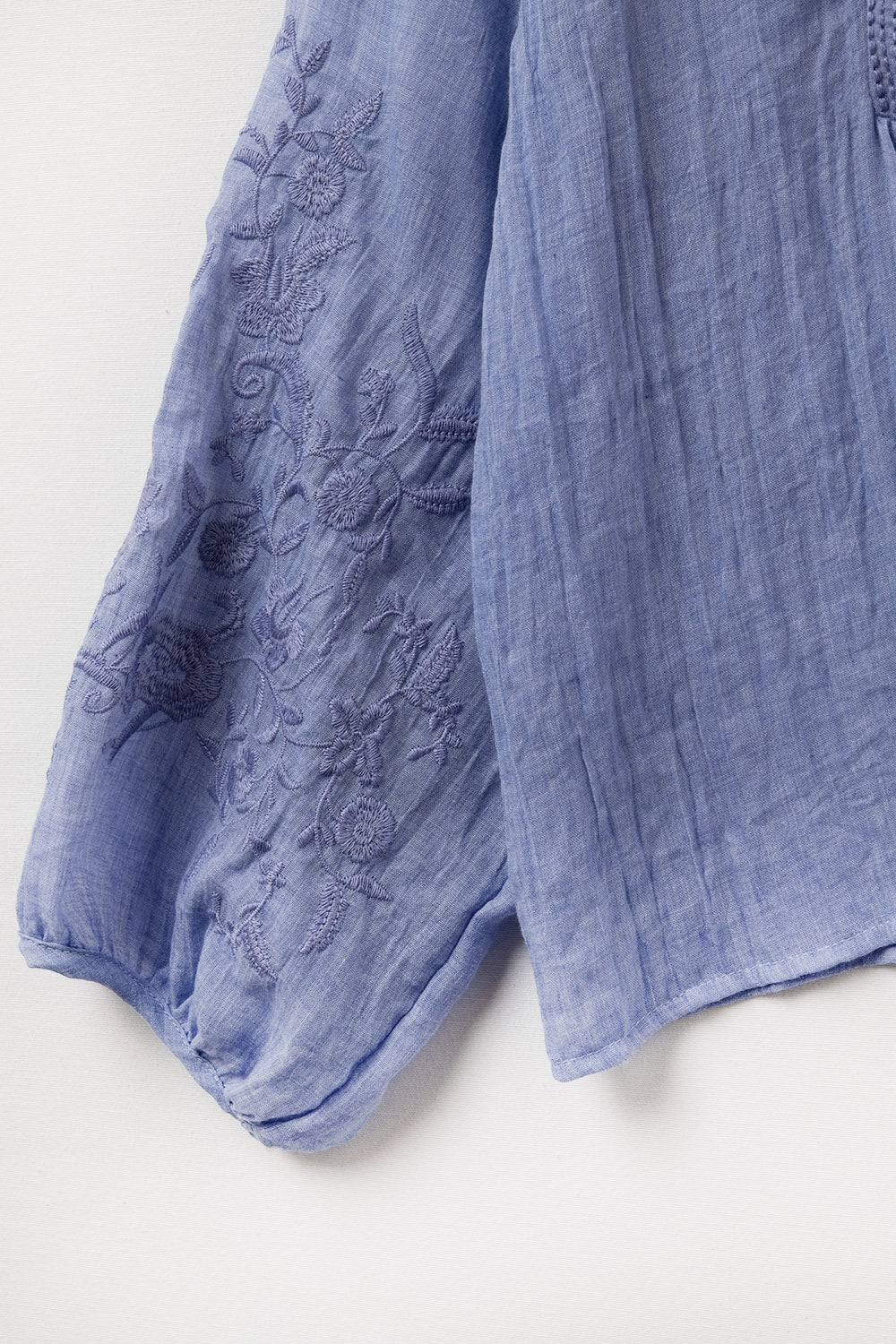Blue chiffon blouse with embroidery on the sleeves