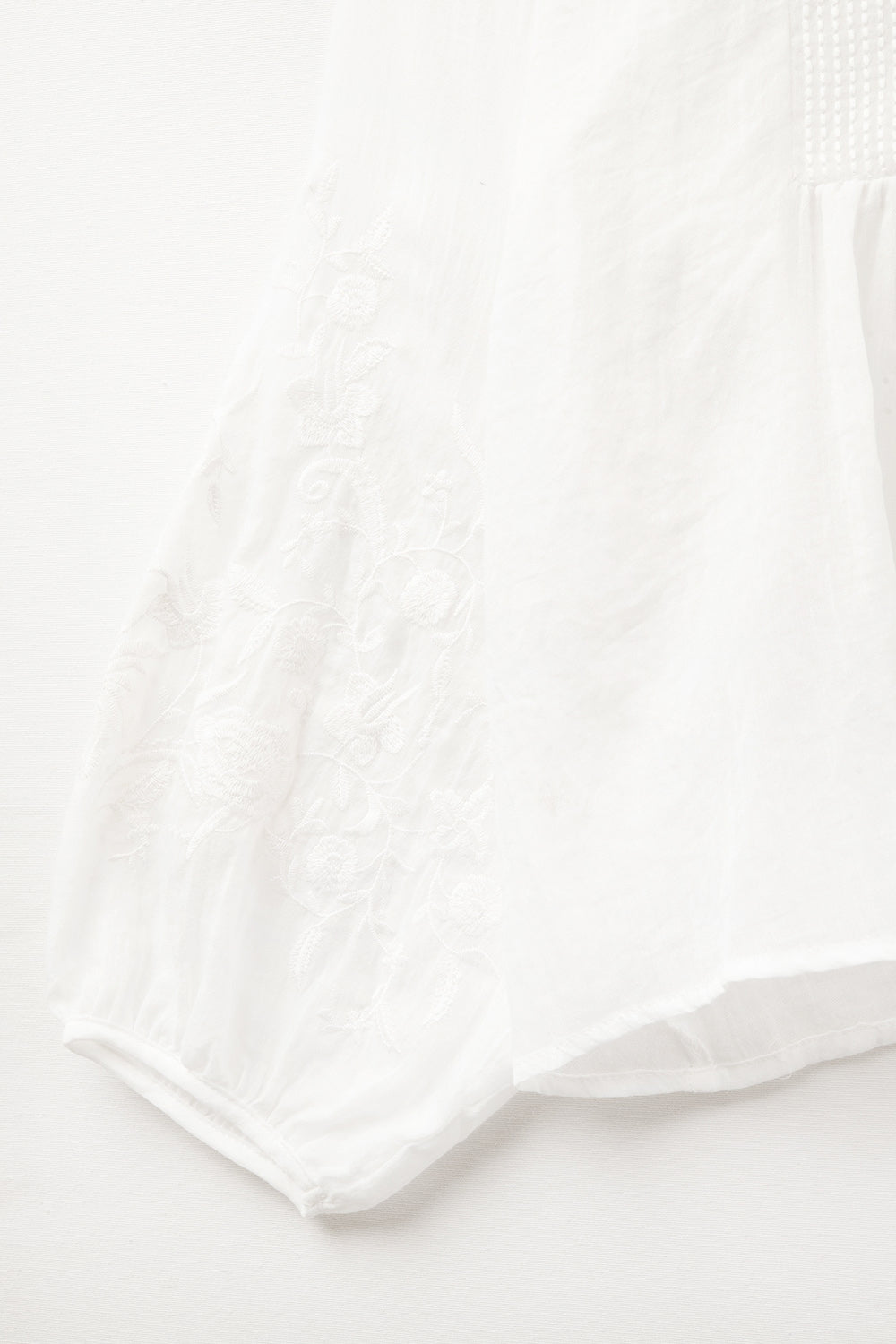 white chiffon blouse with embroidery on the sleeves