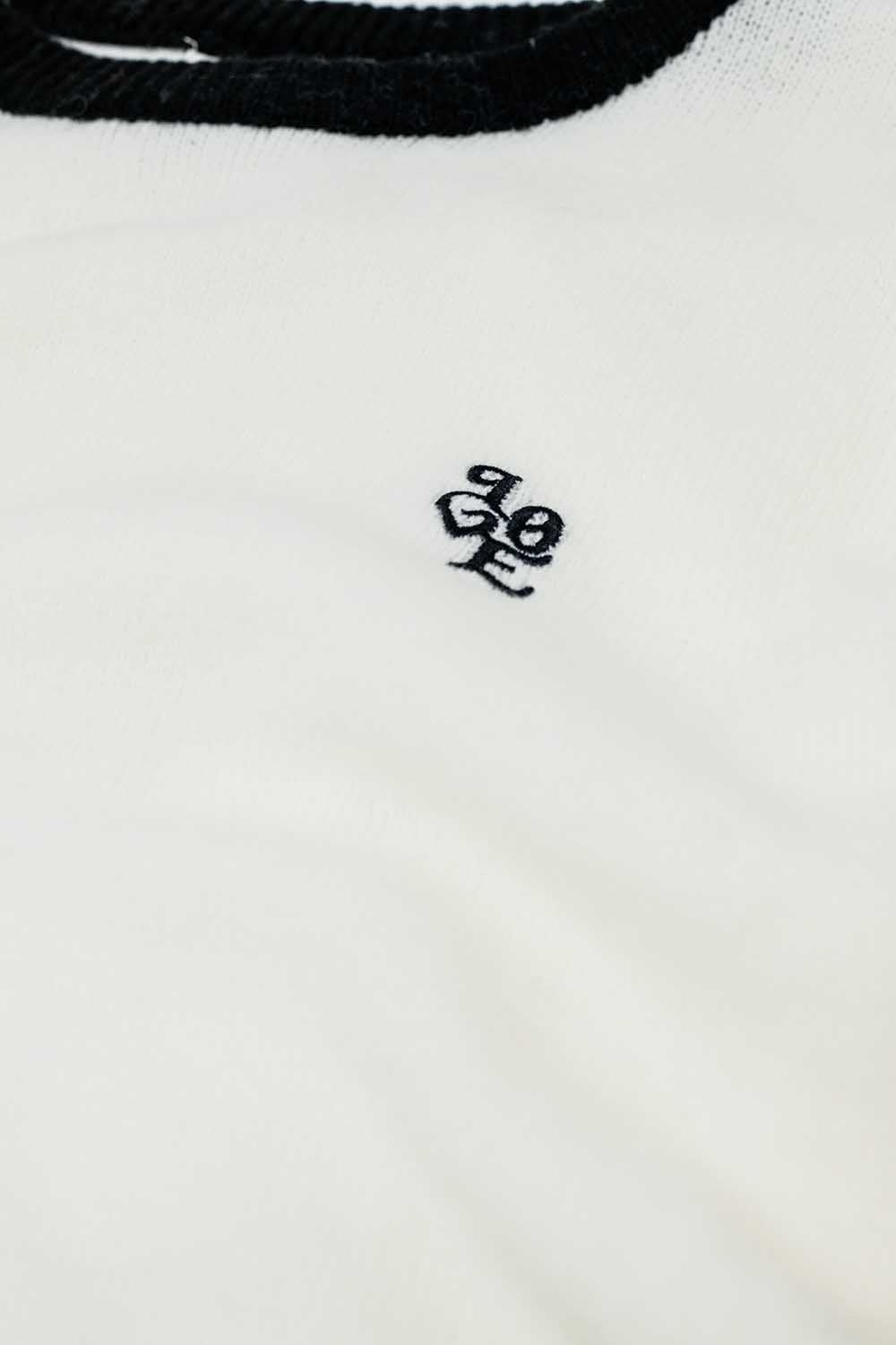 White sweater with contrasting collar and love logo on chest