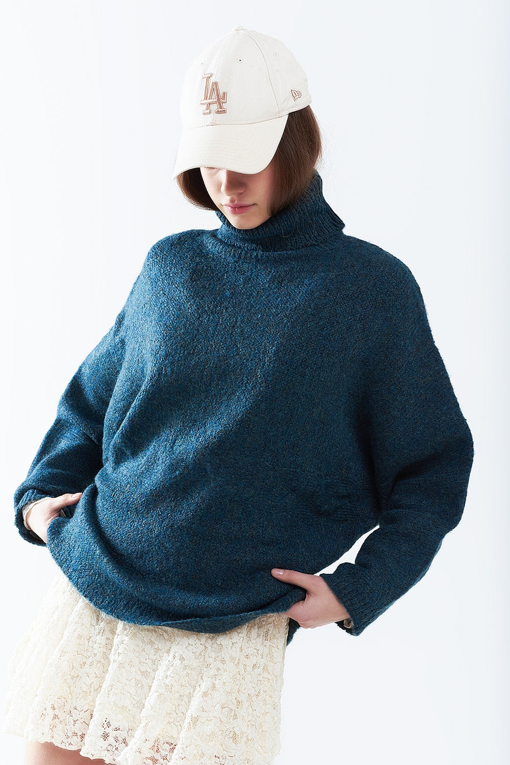 Oversized sweater in teal with a high neck and loose sleeves