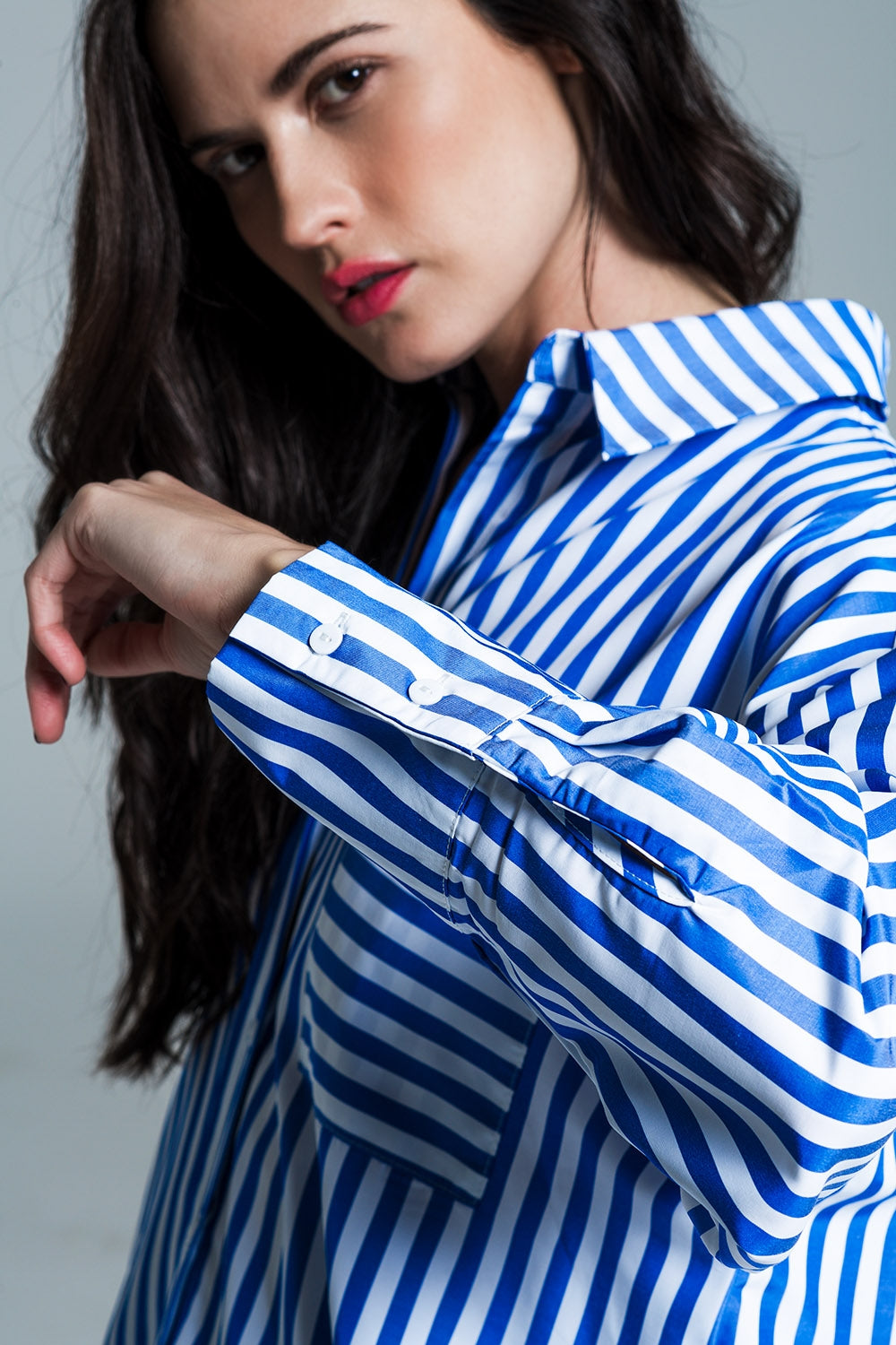 White oversized blouse with vertical stripes in blue and chest pocket