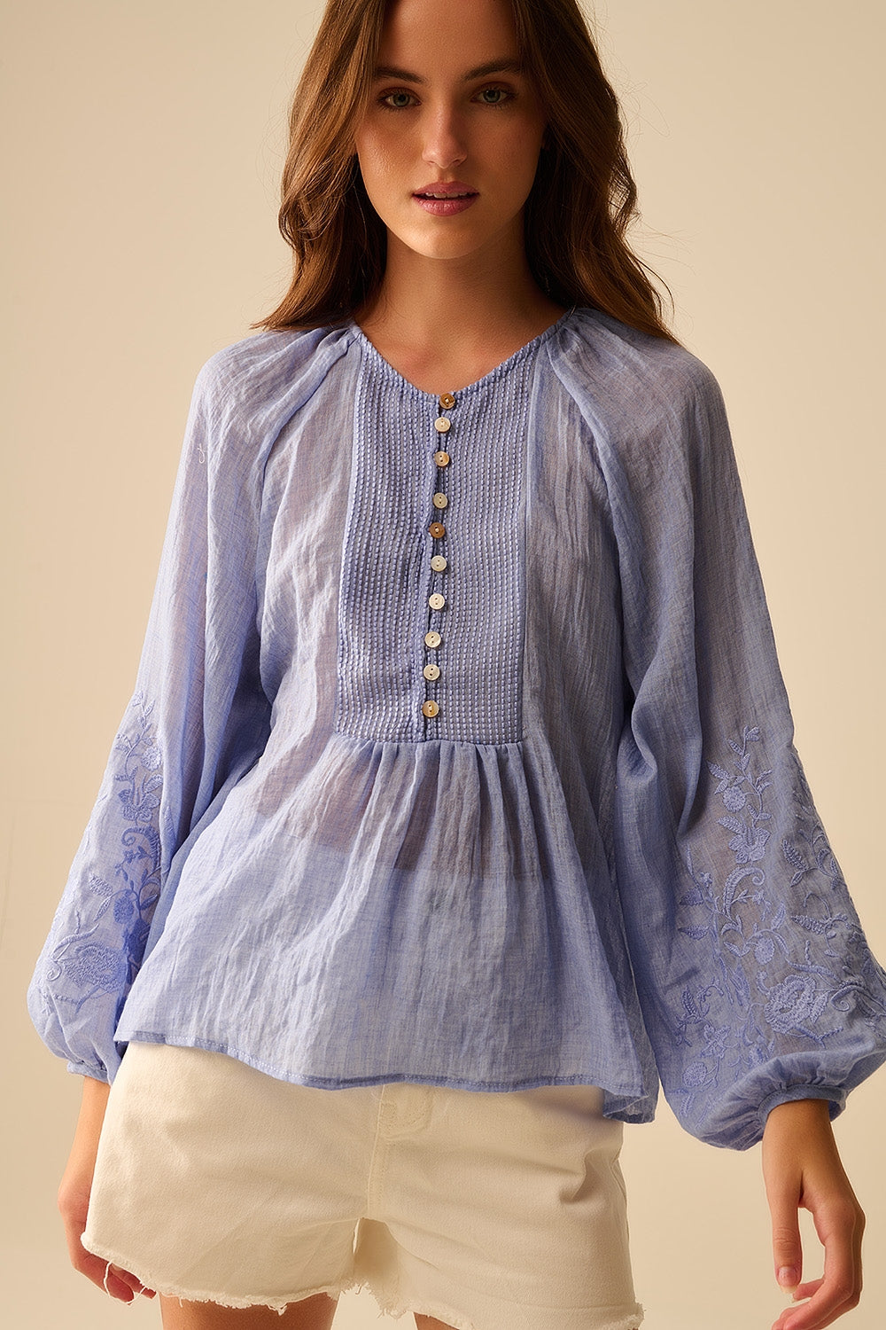 Blue chiffon blouse with embroidery on the sleeves