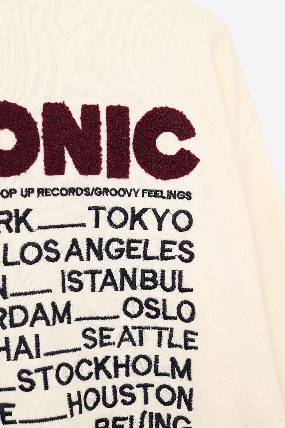 Embroidered ICONIC Sweater with Global Tour Back Print in Cream