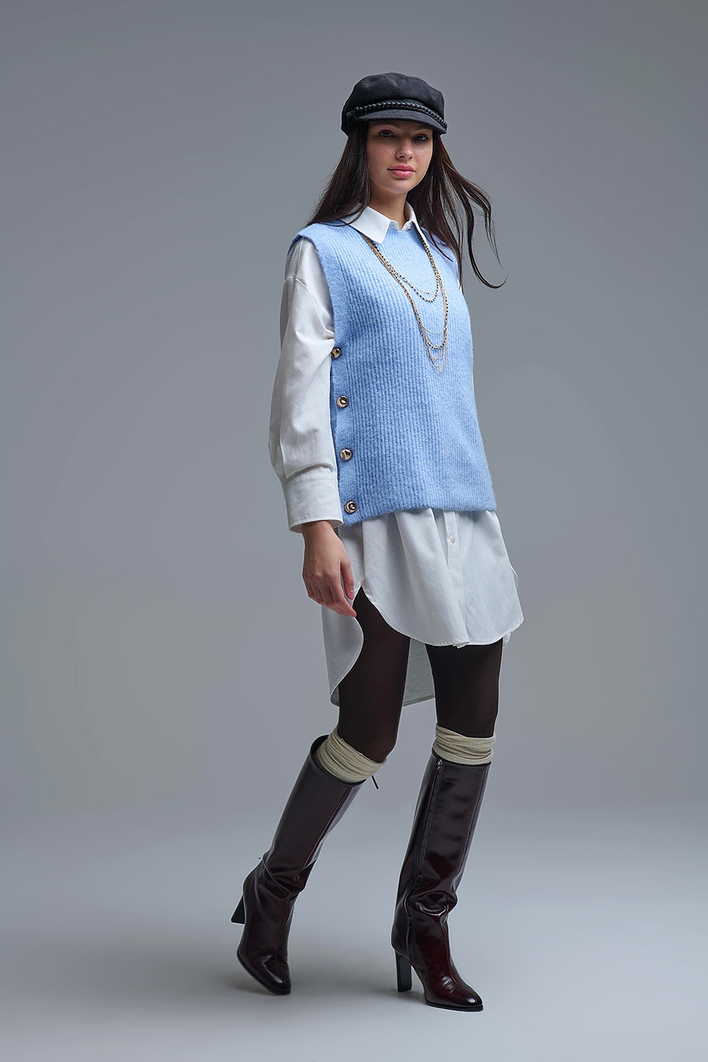 Blue sleeveless sweater with gold buttons on side