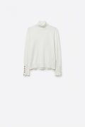 White turtleneck sweater with gold buttons on the cuff