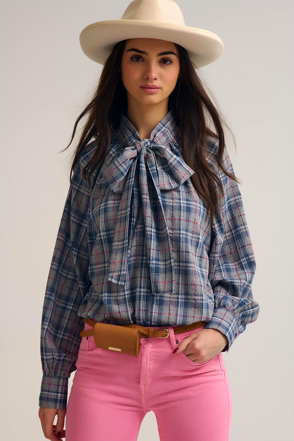 Blue blouse with check print and bow detail at the neck