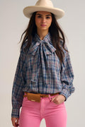 Blue blouse with check print and bow detail at the neck