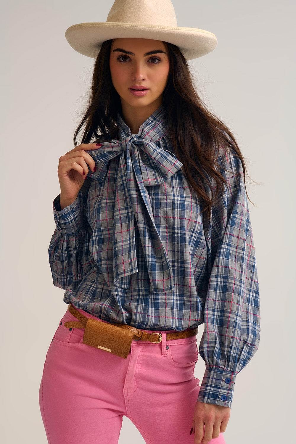 Blue blouse with check print and bow detail at the neck