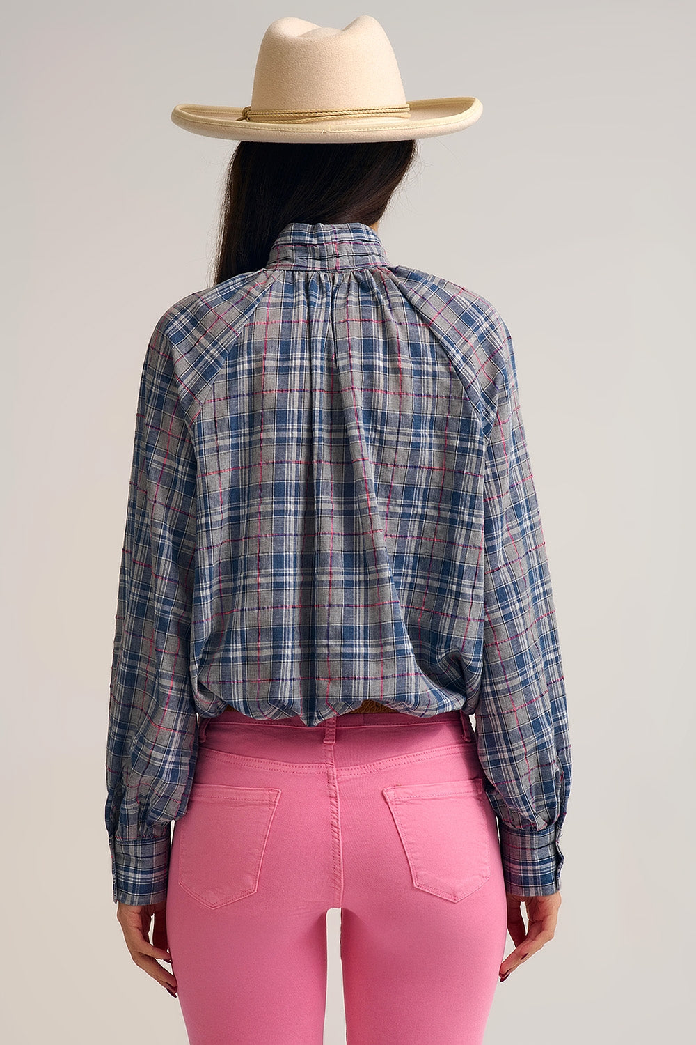 Blue blouse with check print and bow detail at the neck