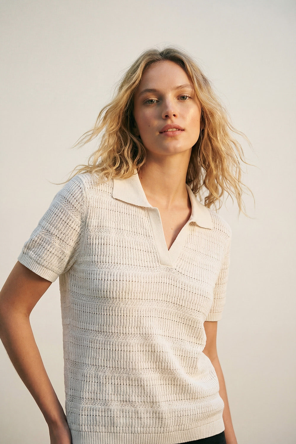 White polo shirt with short sleeves and open knit pattern