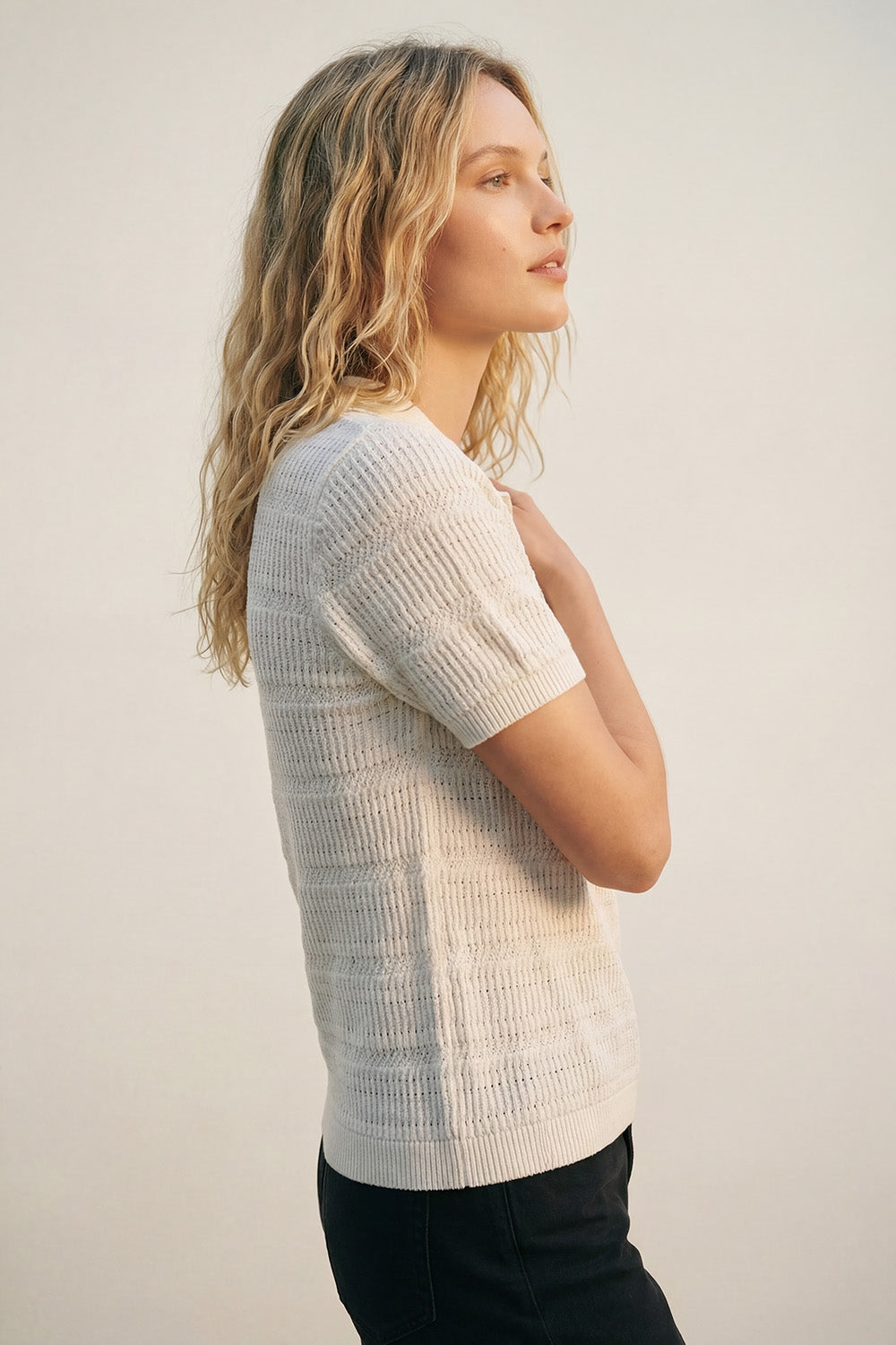 White polo shirt with short sleeves and open knit pattern