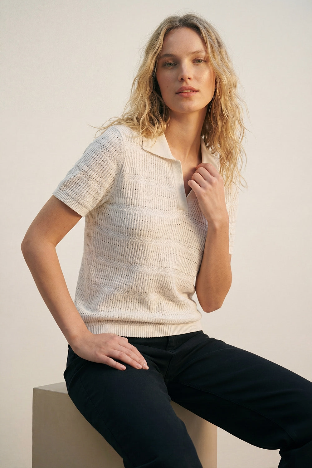 White polo shirt with short sleeves and open knit pattern