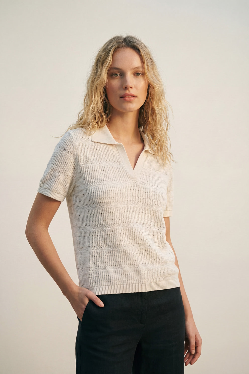 White polo shirt with short sleeves and open knit pattern