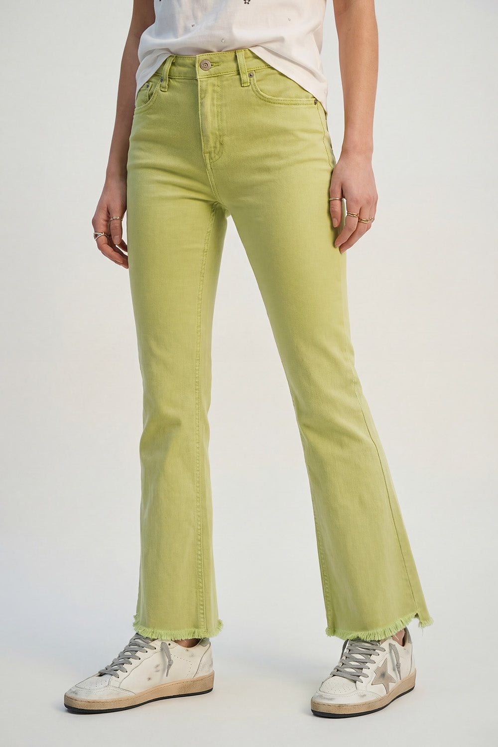 Flare jeans with raw hem edge in lime color