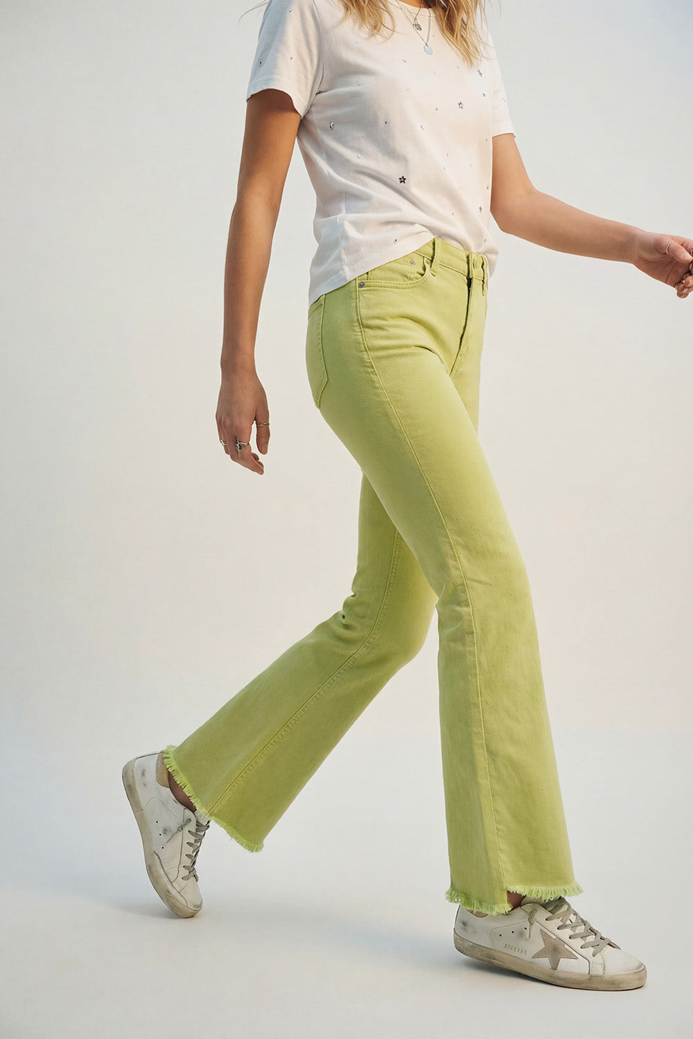 Flare jeans with raw hem edge in lime color