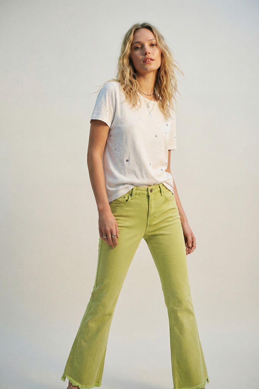 Flare jeans with raw hem edge in lime color