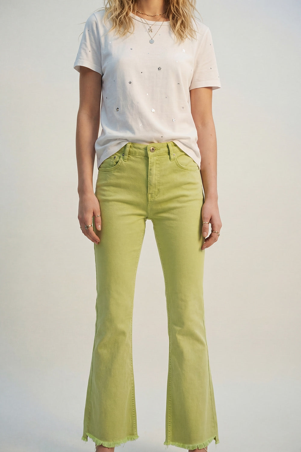 Flare jeans with raw hem edge in lime color