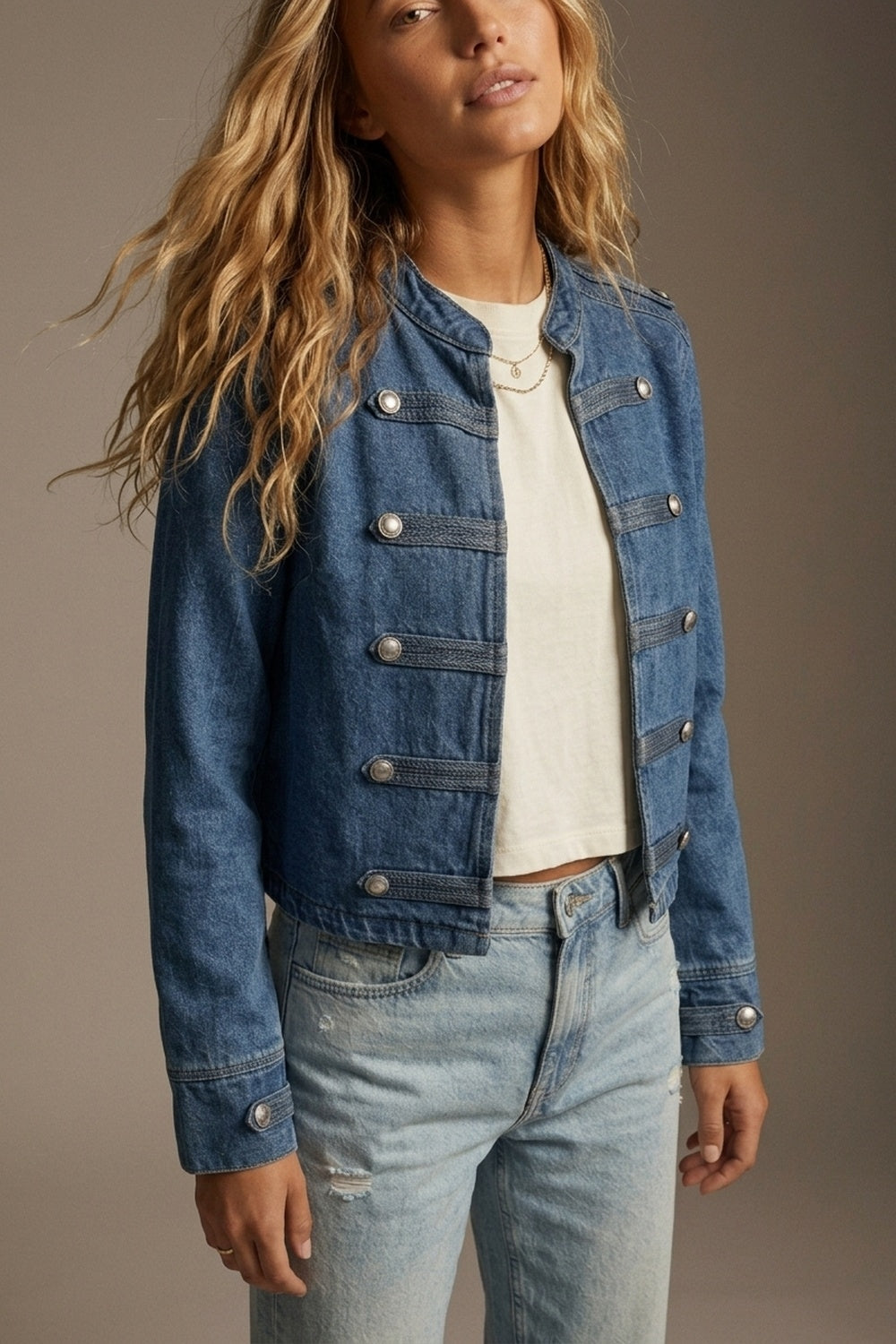 Woman wearing blue cropped rigid denim military-button jacket
