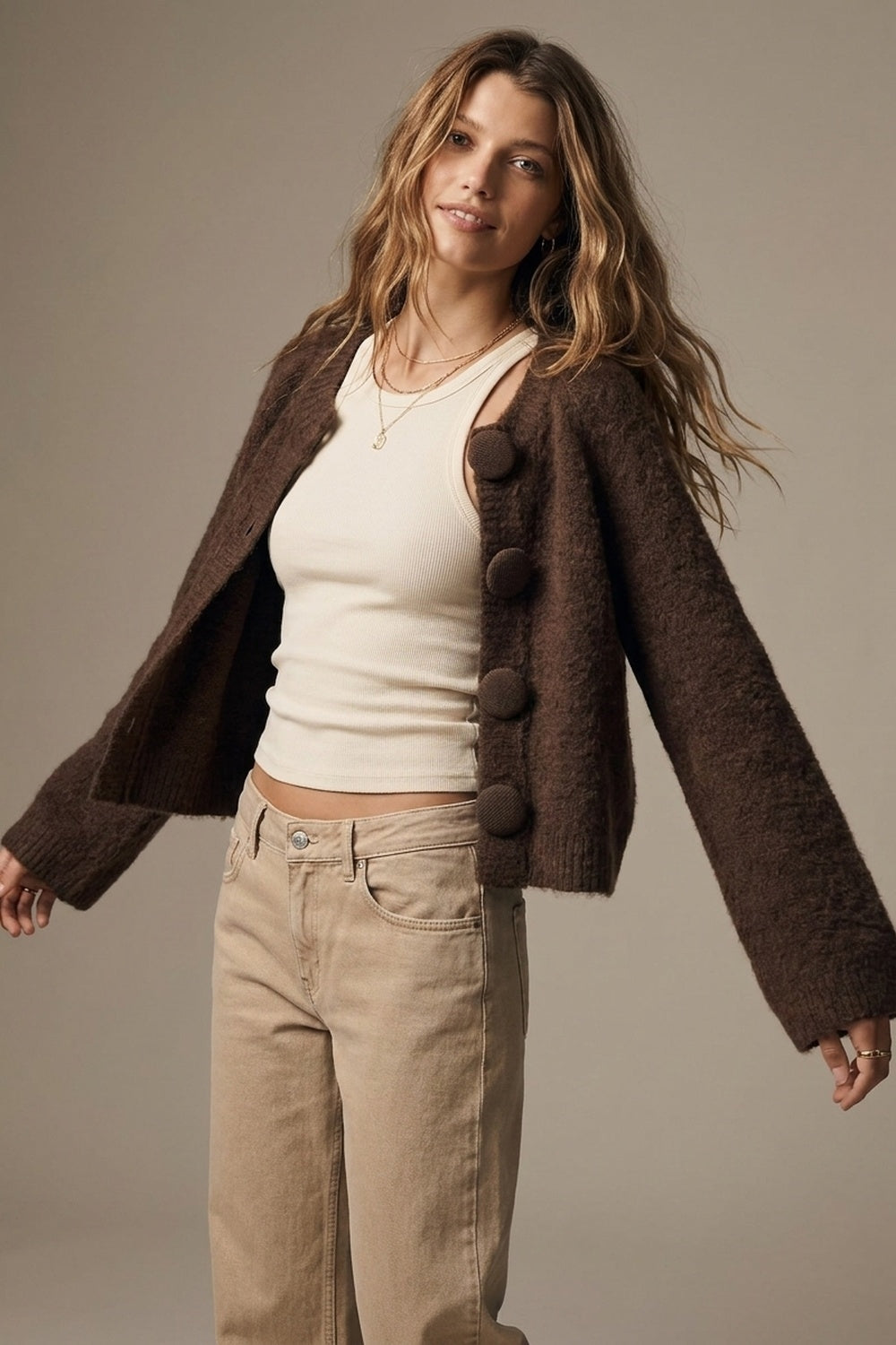 Woman wearing brown fluffy-knit covered-button cropped cardigan