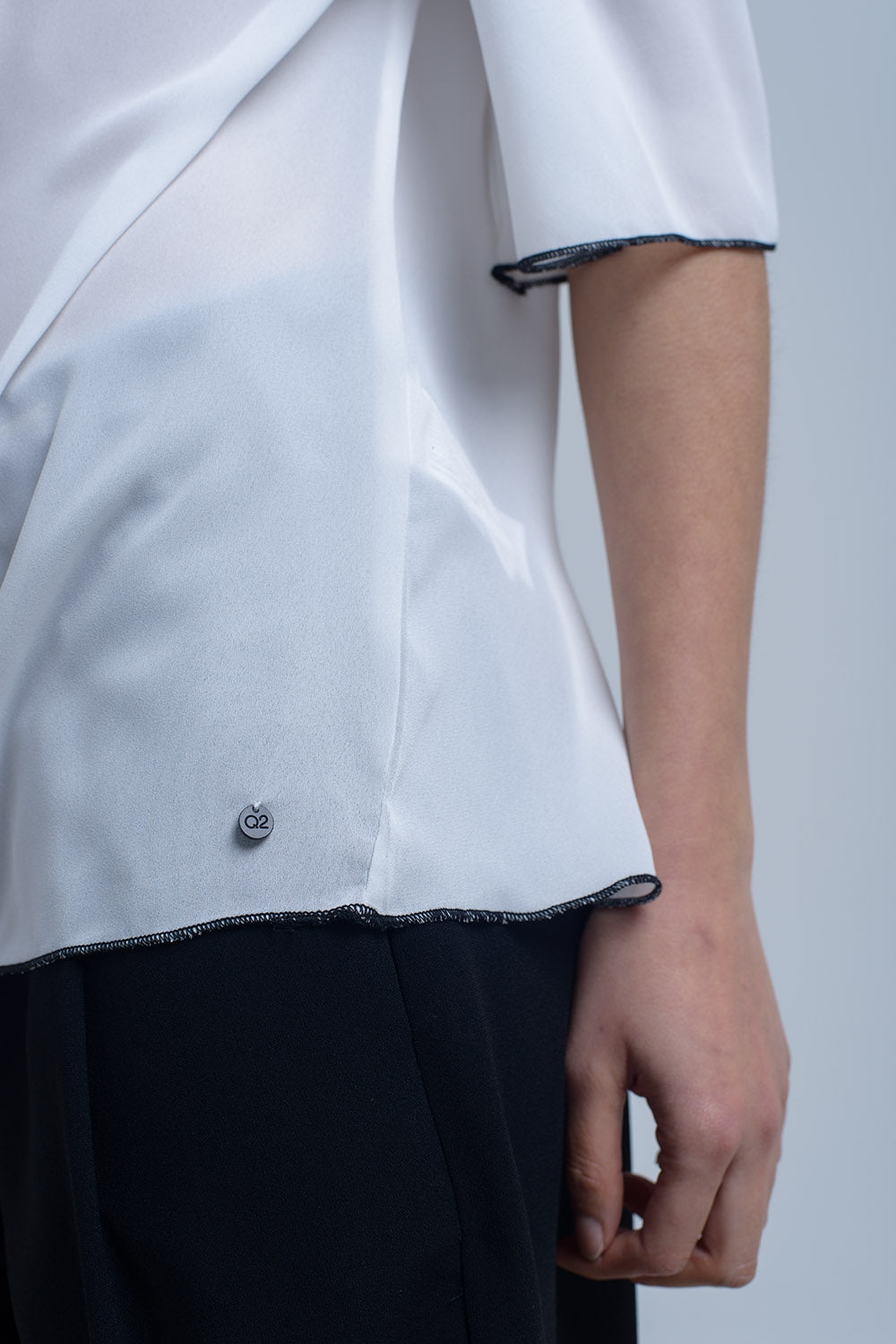 White top with black contrast trim
