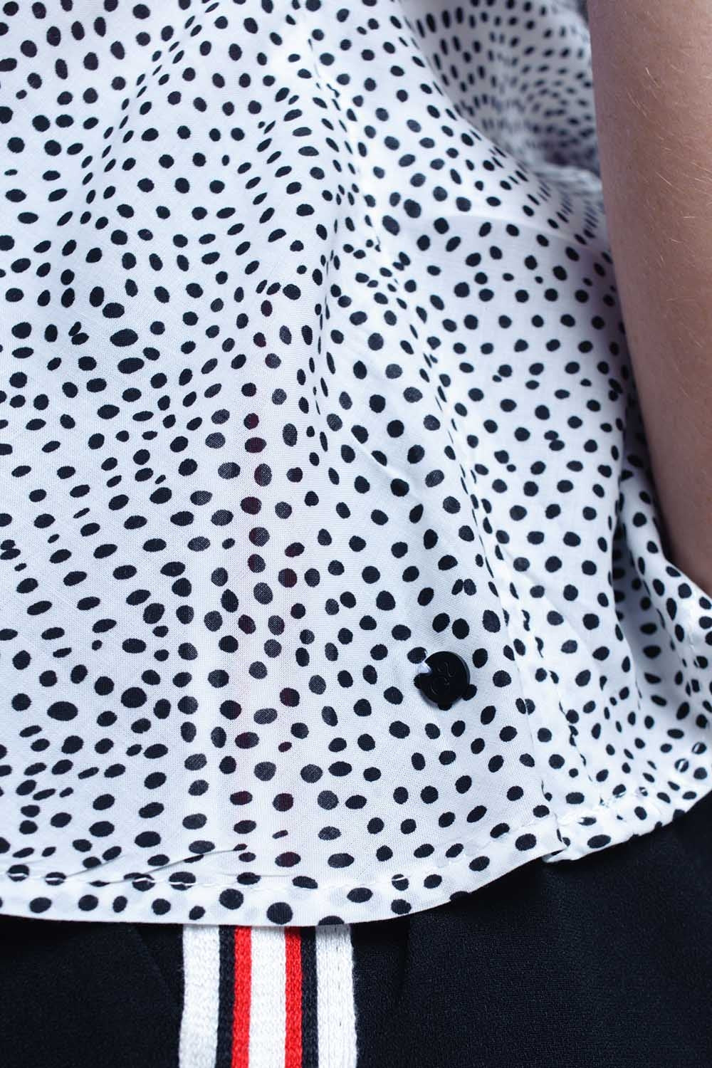White polka dot top with ruffle hem