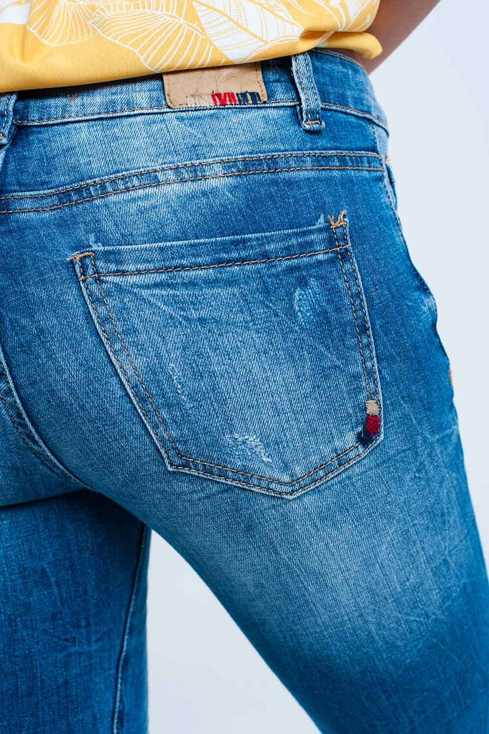 Mid wash fitted jeans with rips
