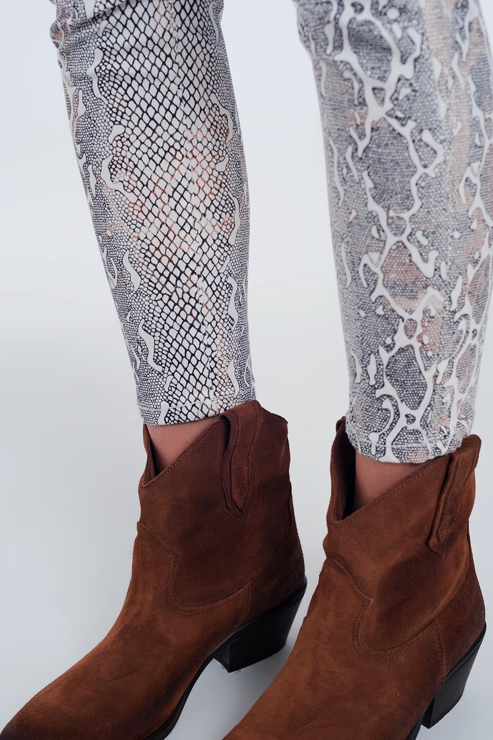 beige coloured pants with snake print