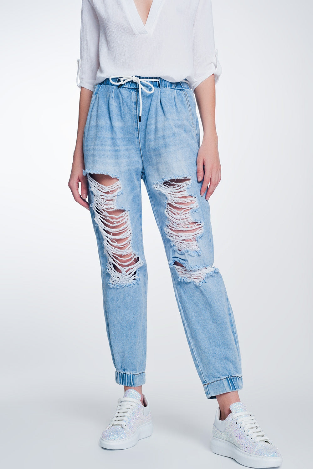 Heavily ripped boyfriend jeans in light denim