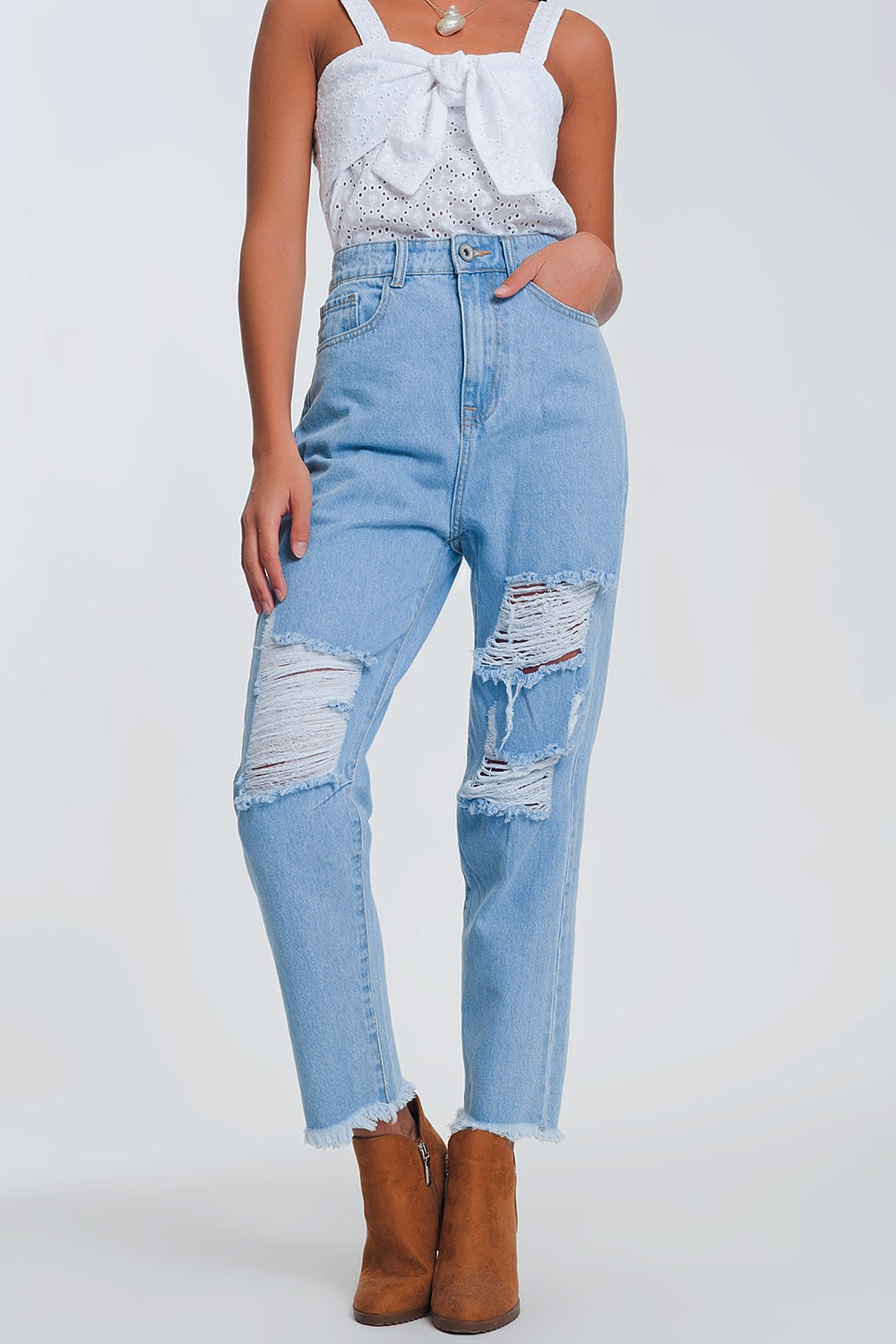 High waist mom jeans with busted knees in light denim
