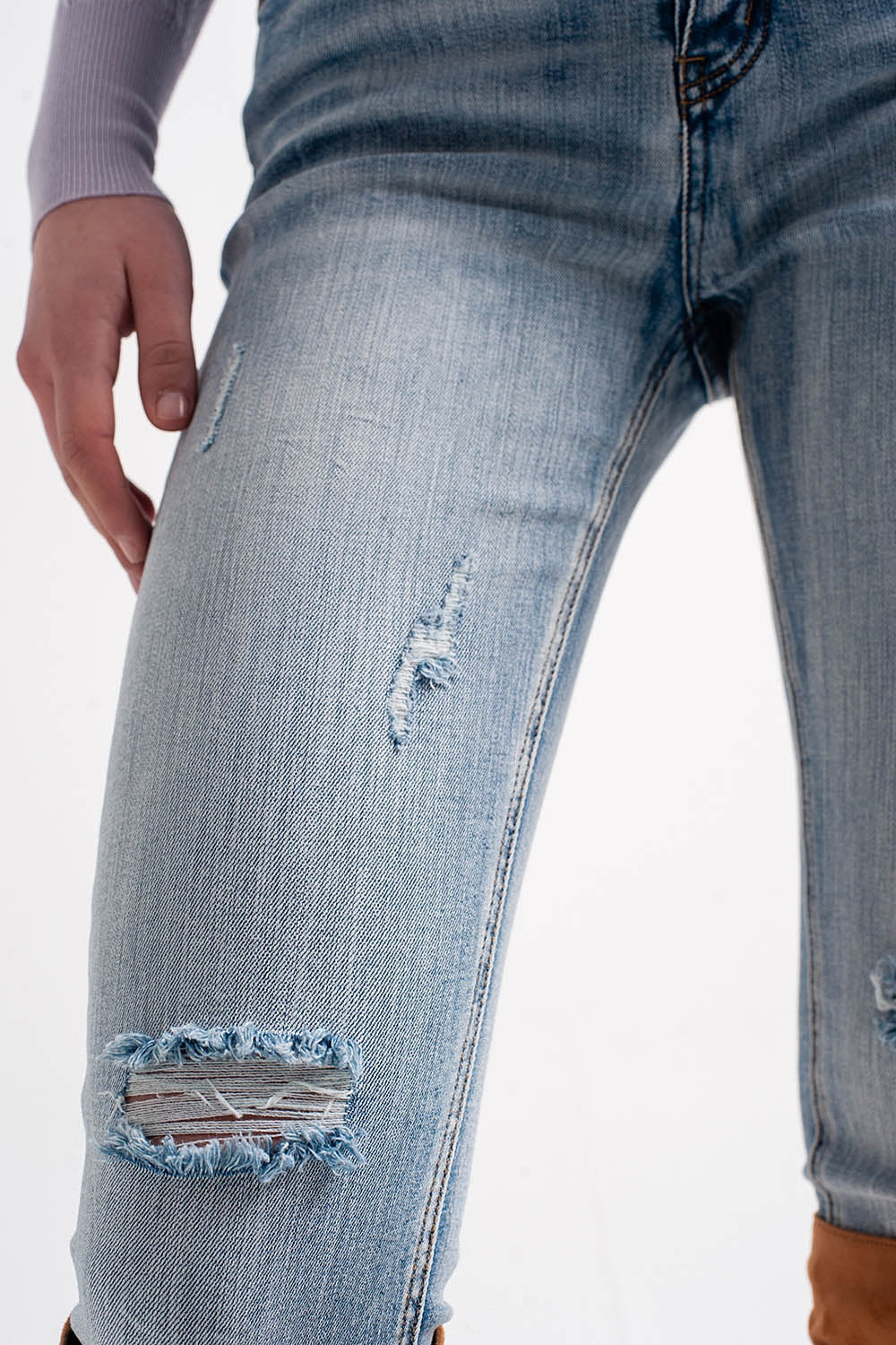 Heather skinny leg distressed jeans with button detail in light blue
