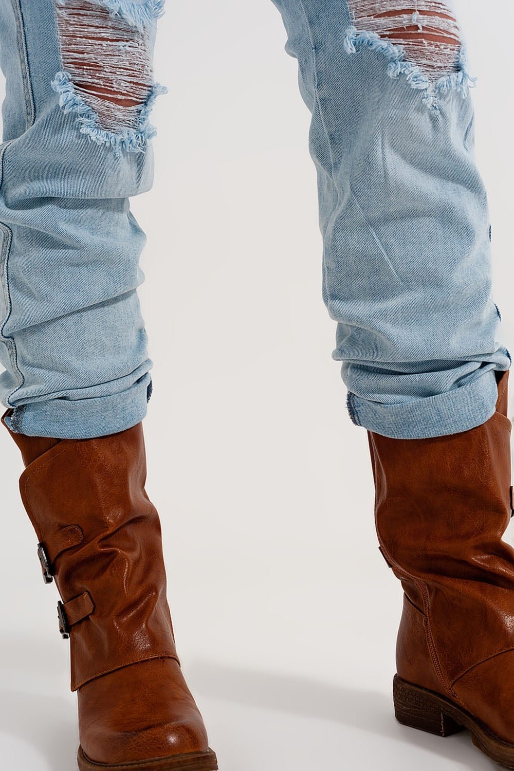 Straight leg distressed jeans with button detail in light blue