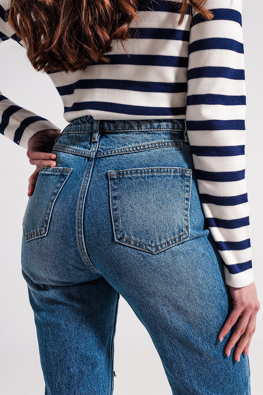 Asymmetric button detail jeans in mid blue