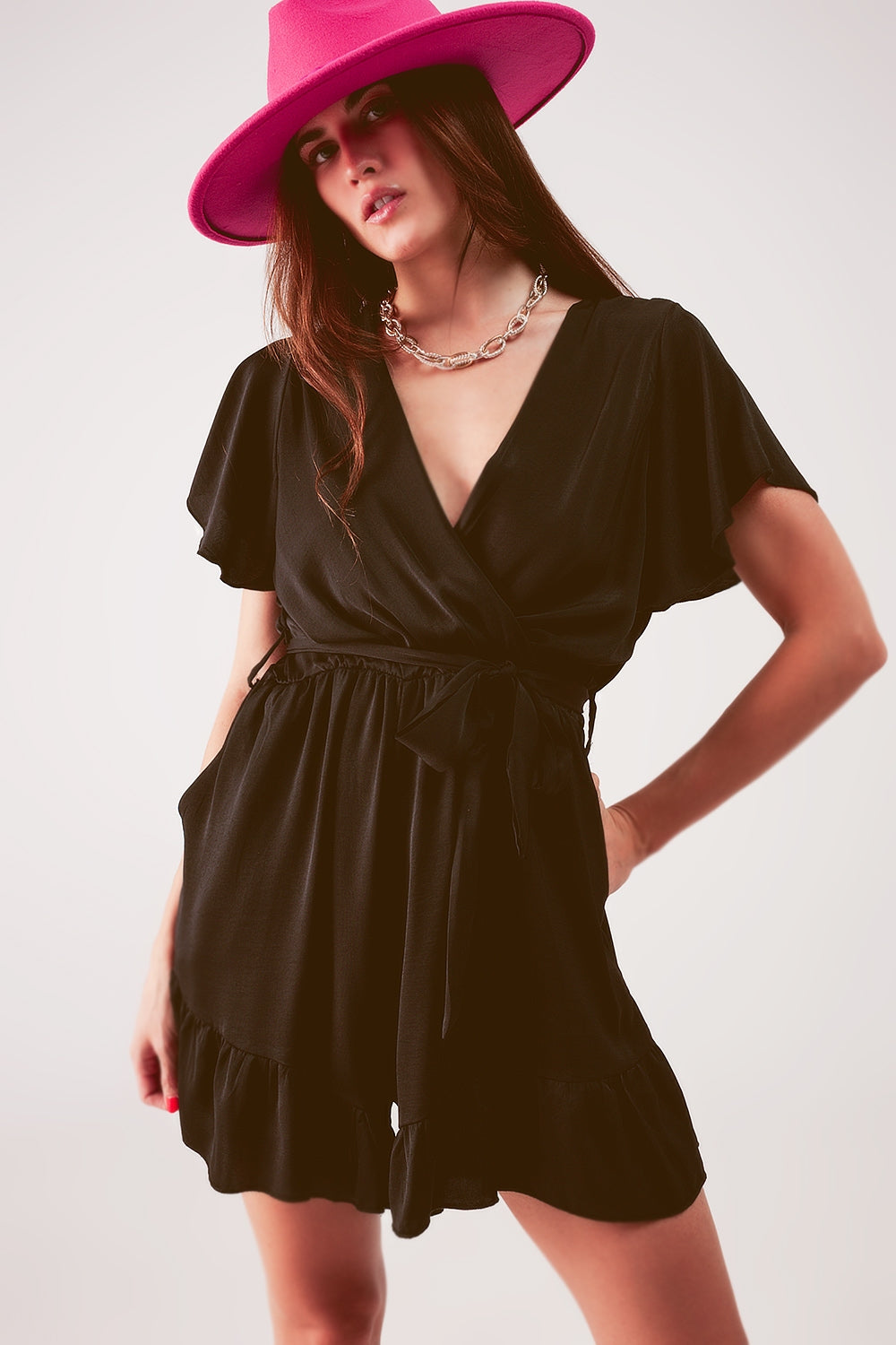 UNIKCOSA Wrap front frill hem jumpsuit in black