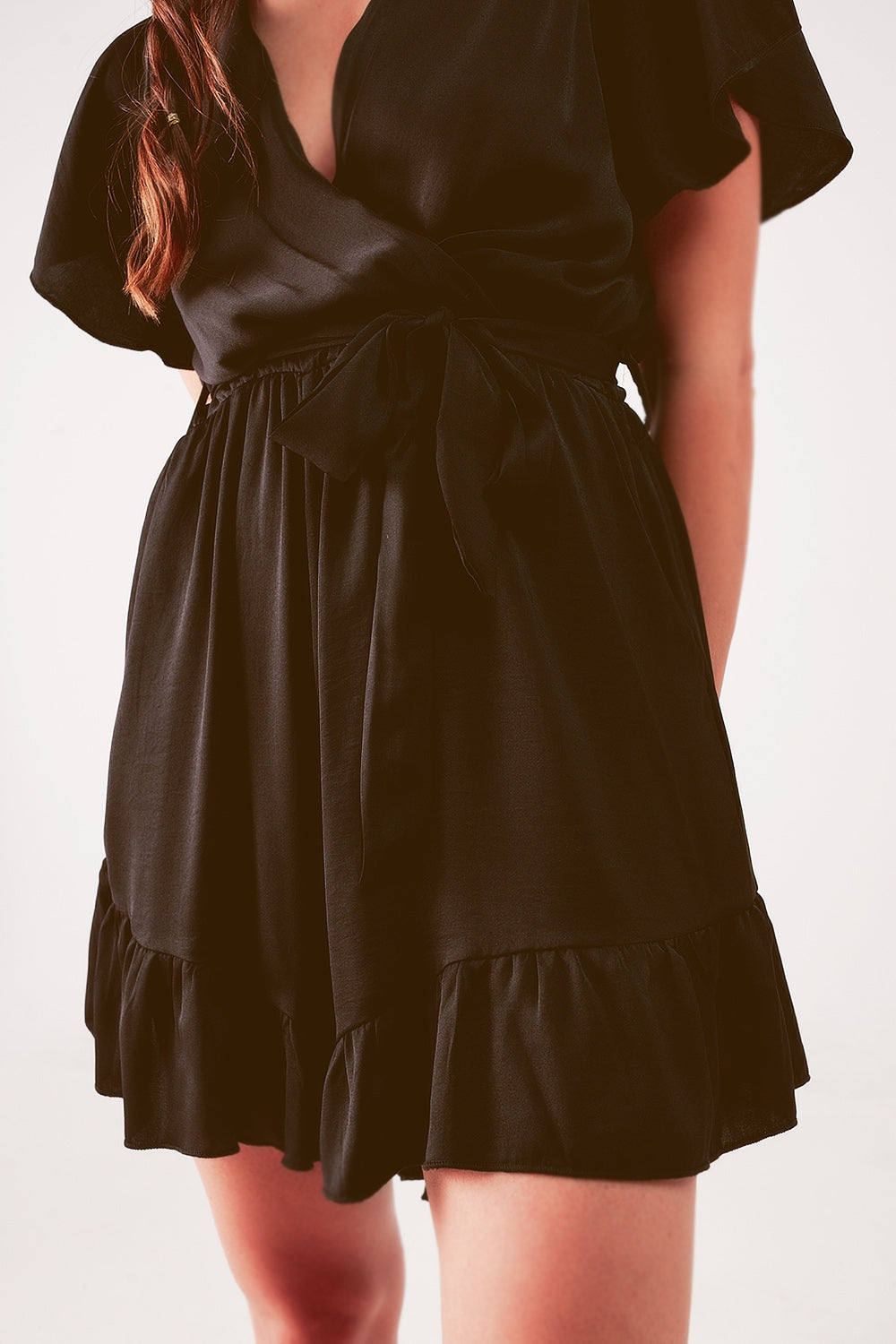 UNIKCOSA Wrap front frill hem jumpsuit in black