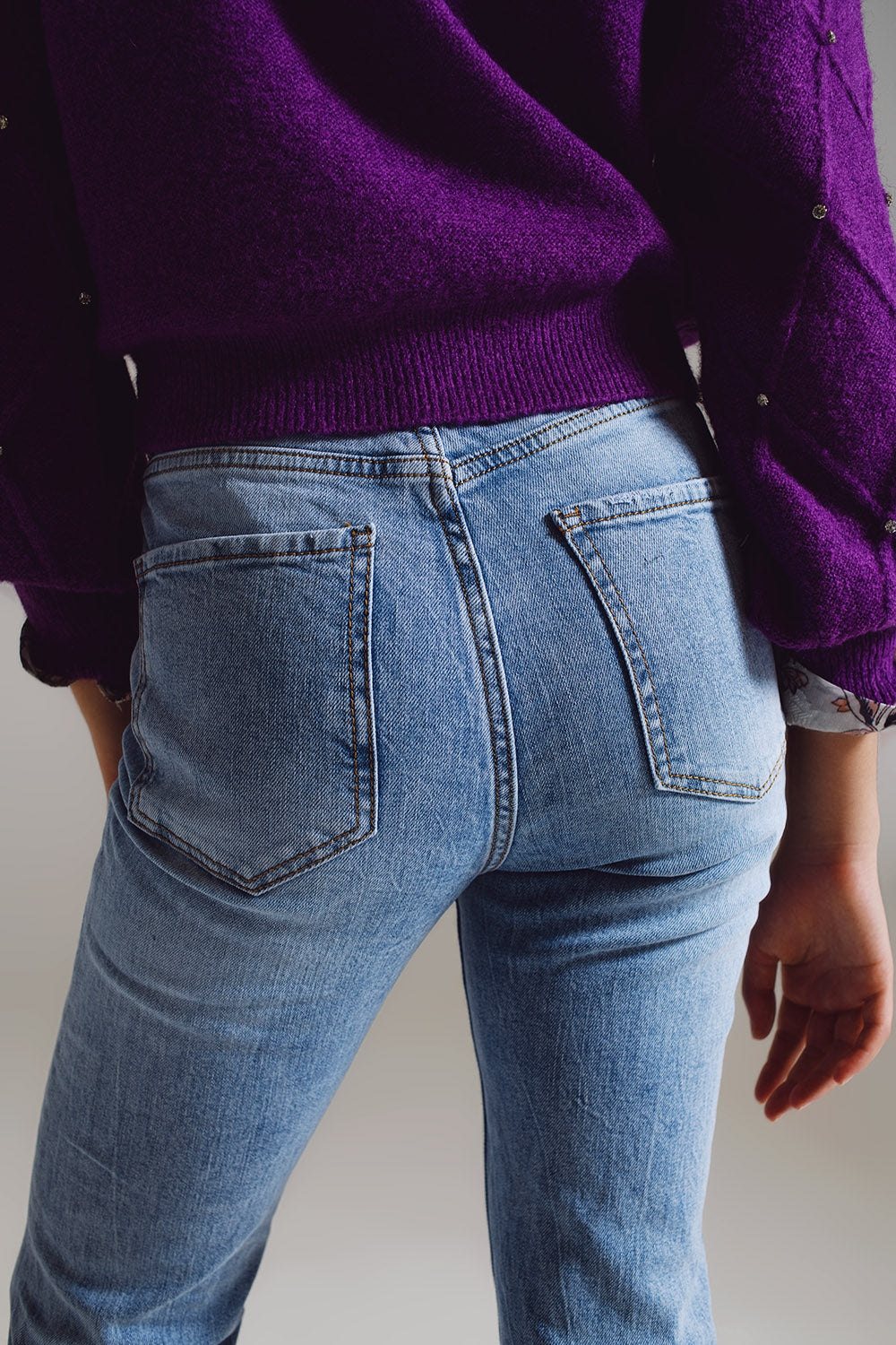 Straight leg jeans with distressed hem in light blue
