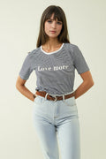 White T-shirt with black stripes and Love More texted