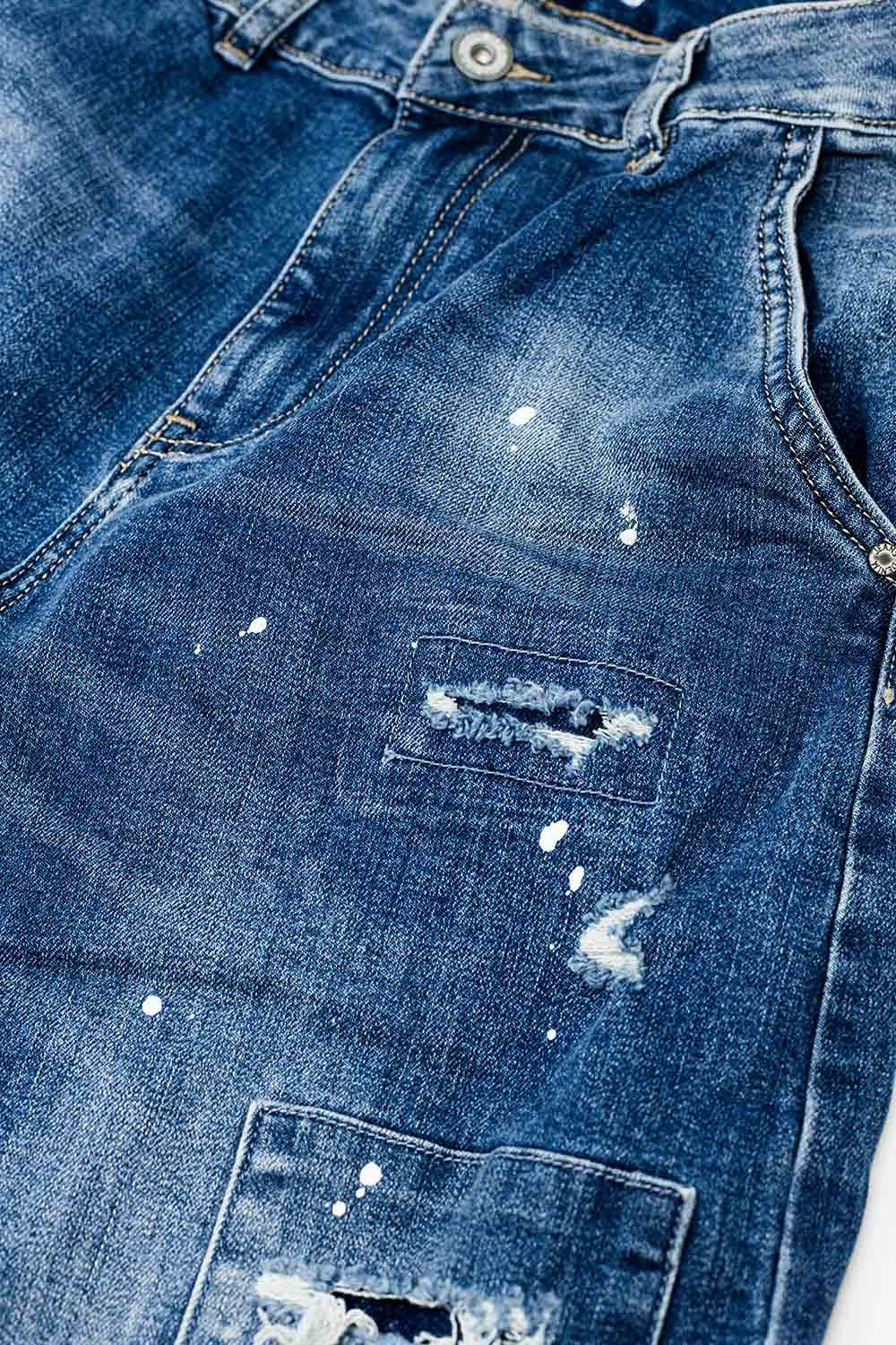 Loose-fitting jeans with distressed patches and paint details
