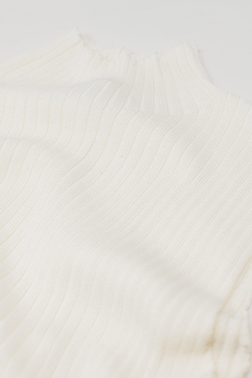 Sleeveless fine knit wool sweater in ecru