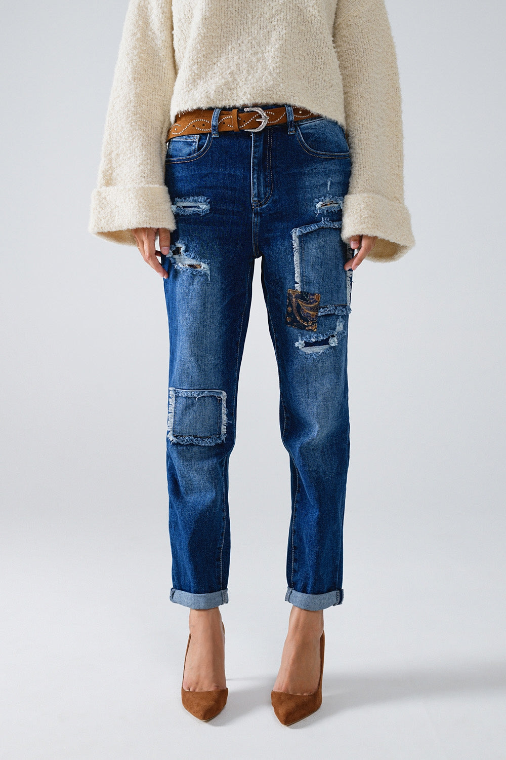 Loose blue jeans with subtle ripped design and patches