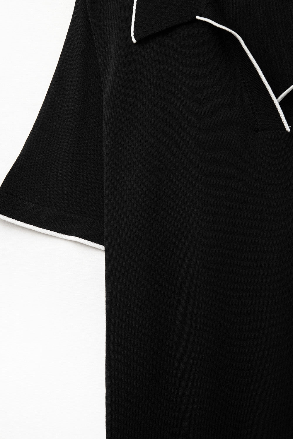 Black knit polo shirt with contrasting detail in white