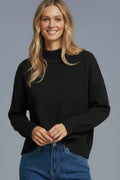 Black soft knit sweater with ribbed cuffs and neck