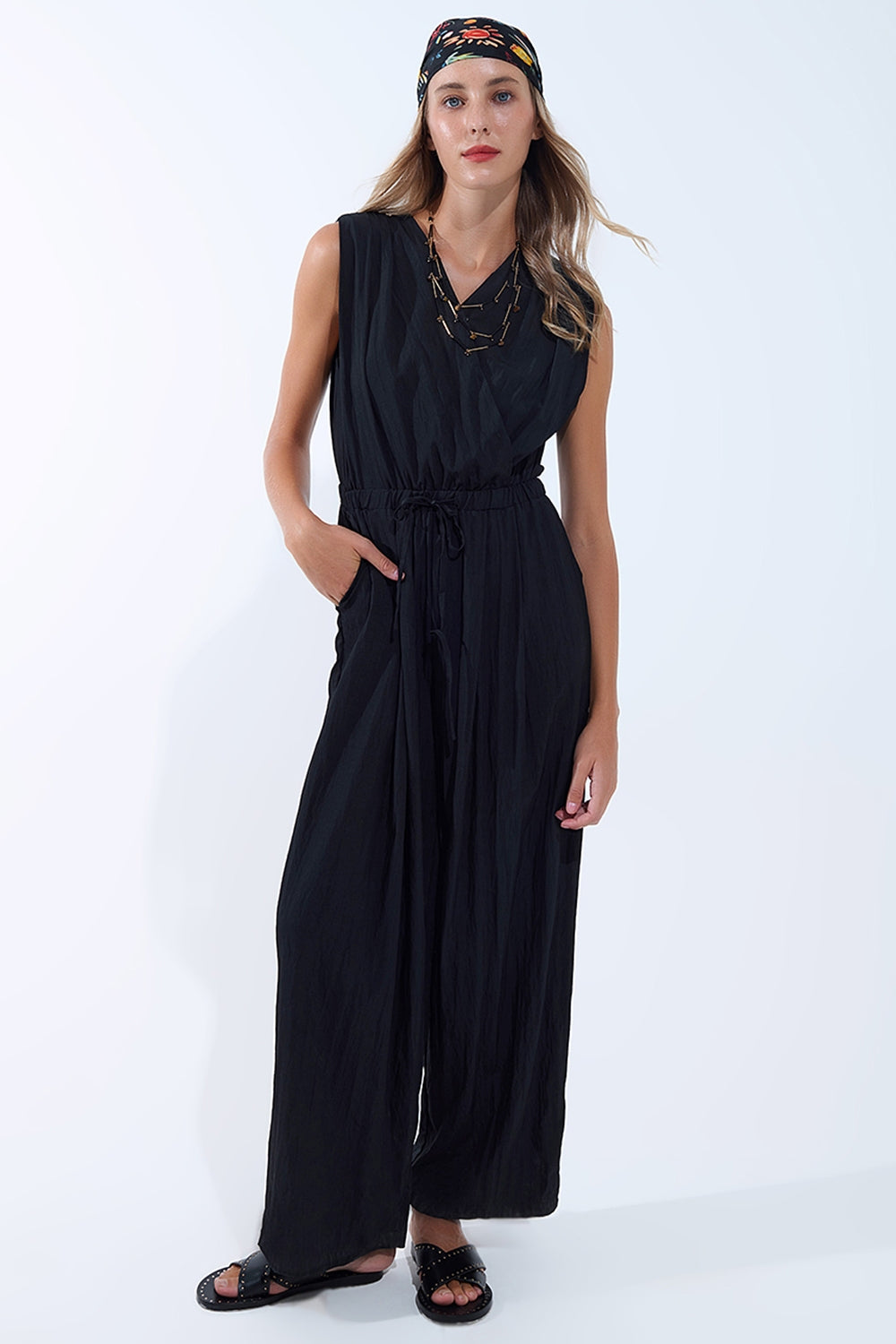 draped black jumpsuit in crinkled fabric