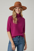 Fine knit sweater in fucsia with a high neck and elbow-length sleeves