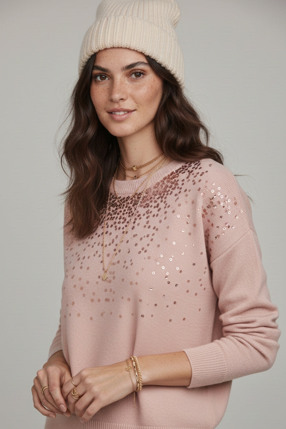 Pink soft knit sweater embellished with sequins on the front