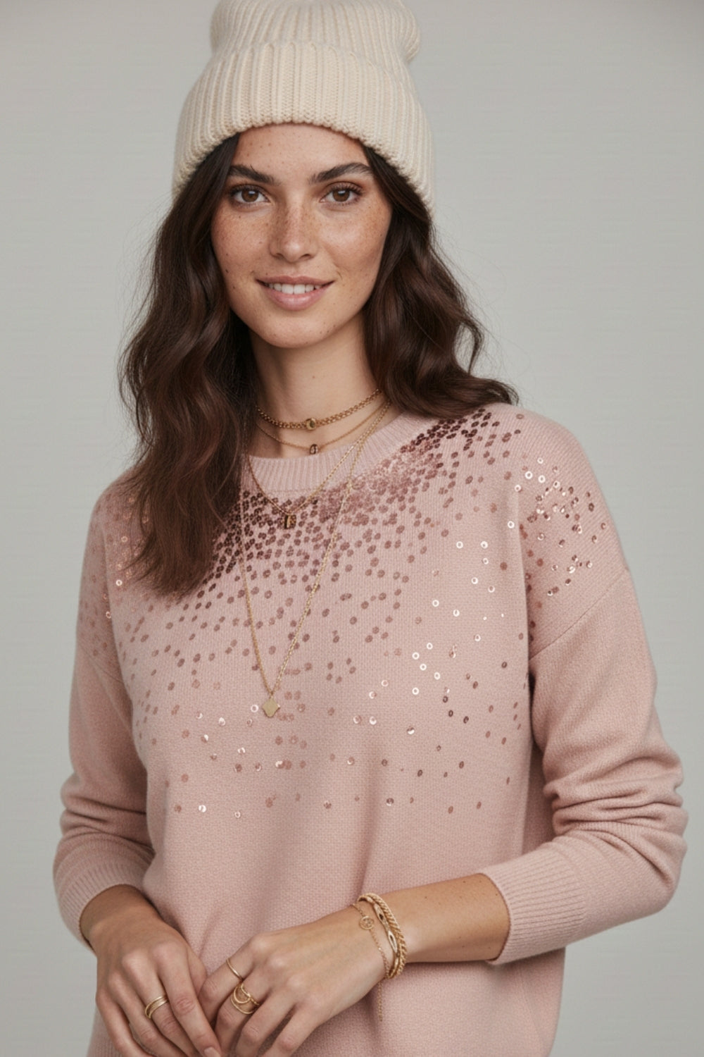 Pink soft knit sweater embellished with sequins on the front