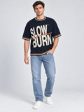 Slow Burn oversized cotton T-shirt — campaign on-model digital styling illustration with denim