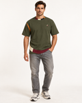 Olive Counterform boxy cotton T-shirt — front on-model AI styling illustration